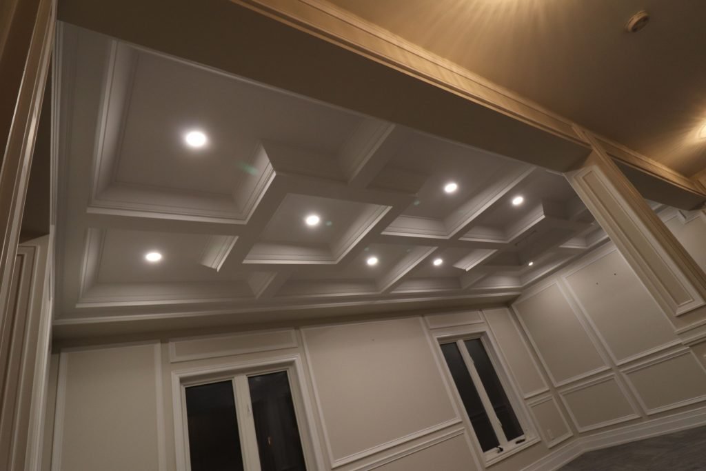custom living room with waffle ceilings 